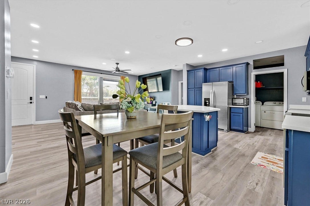 An open-concept living area boasts a vibrant kitchen island and seamless flow to the dining and living spaces.