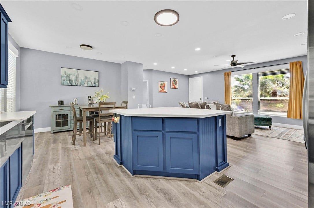 An inviting open-concept layout features a spacious kitchen island and continuous flooring into the living area.