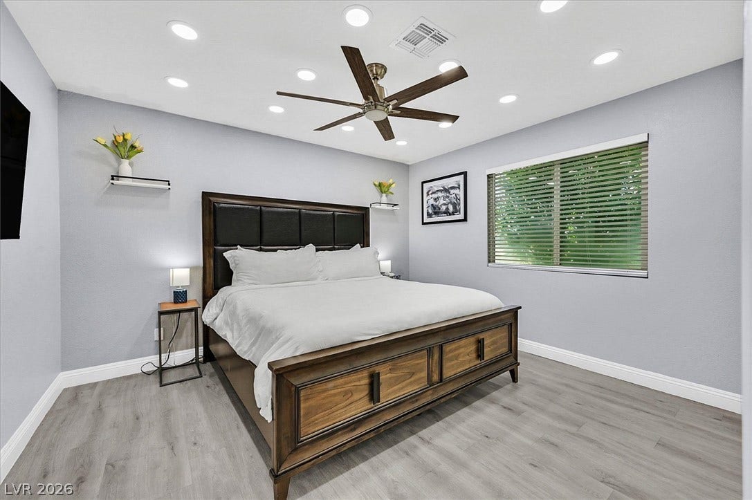 Well-lit sleeping quarters with a ceiling fan and elegant flooring for ultimate comfort.