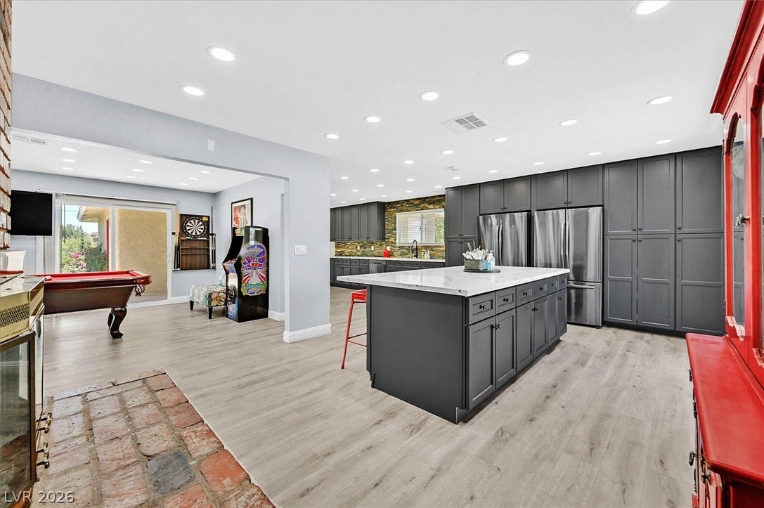 Culinary delights await in this modern kitchen with ample storage and sleek stainless steel appliances.