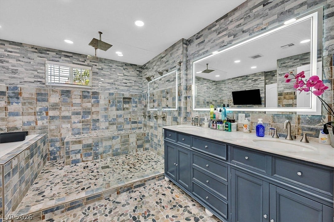 Luxurious spa-like retreat with a spacious walk-in shower and elegant dual vanity.