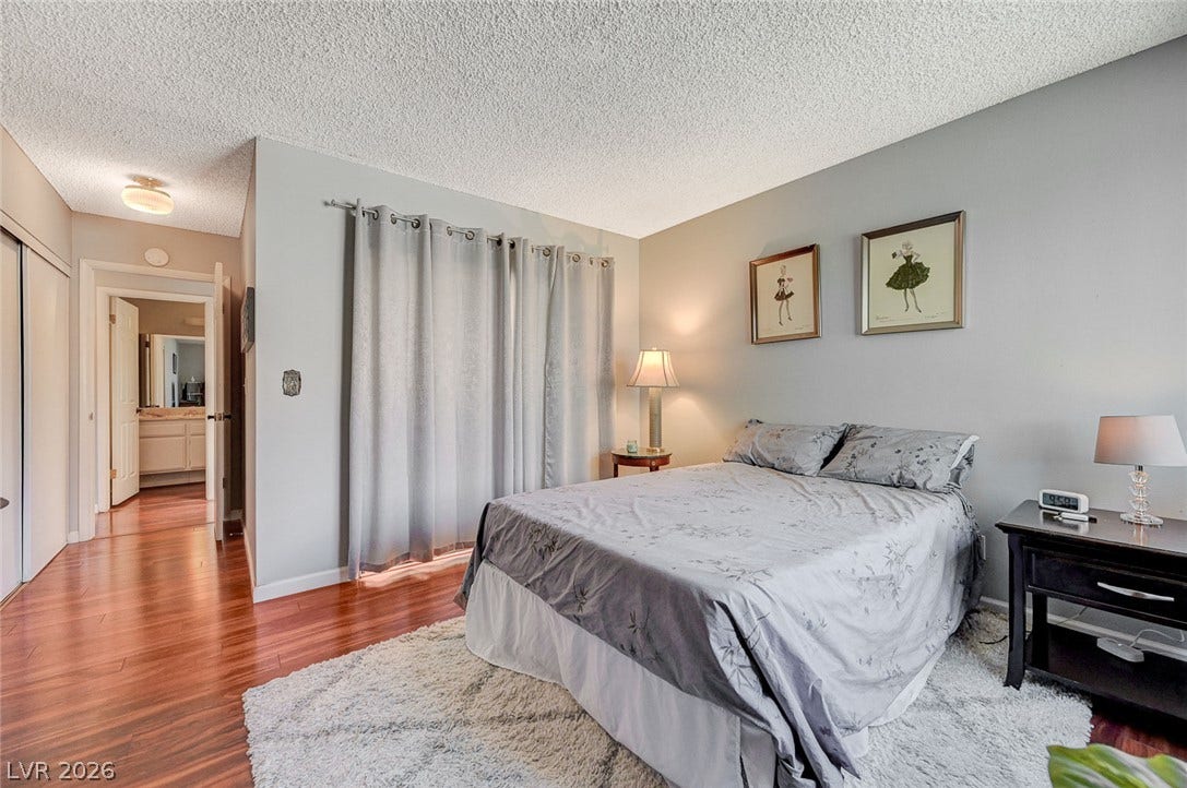 Gleaming hardwood floors and a spacious closet define this inviting bedroom space.