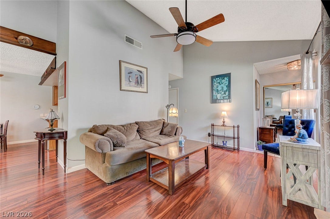 Soaring vaulted ceilings and rich wood floors create an inviting and airy atmosphere.