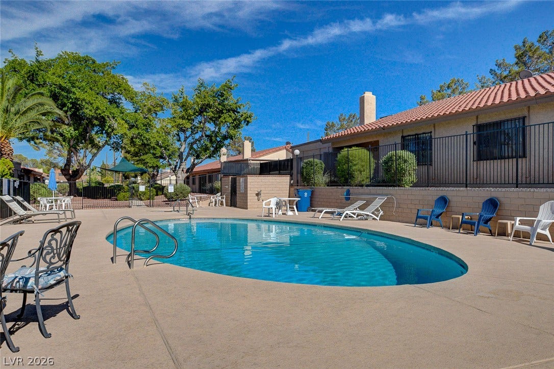 A sparkling swimming pool serves as the centerpiece of this outdoor community space.
