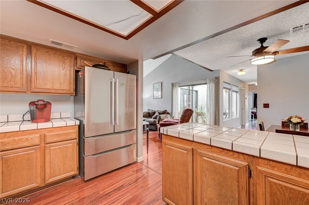 Gleaming wood-look floors anchor a functional kitchen layout with generous counter space.