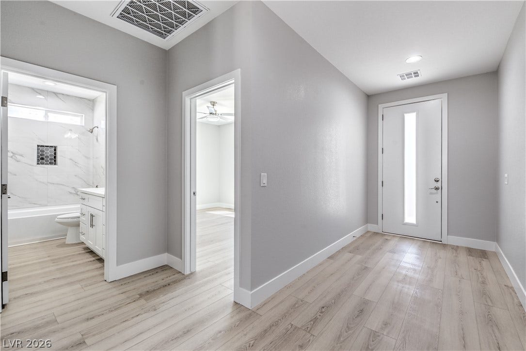 Entryway featuring light wood-type flooring and a ceiling fan