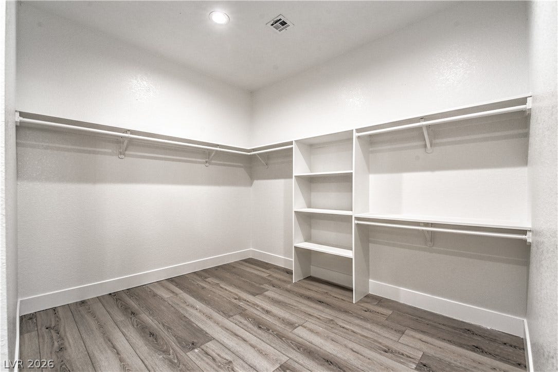 Walk in closet featuring light wood-style floors