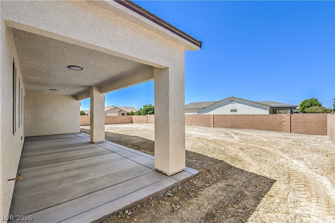 Fenced backyard with a patio and a residential view