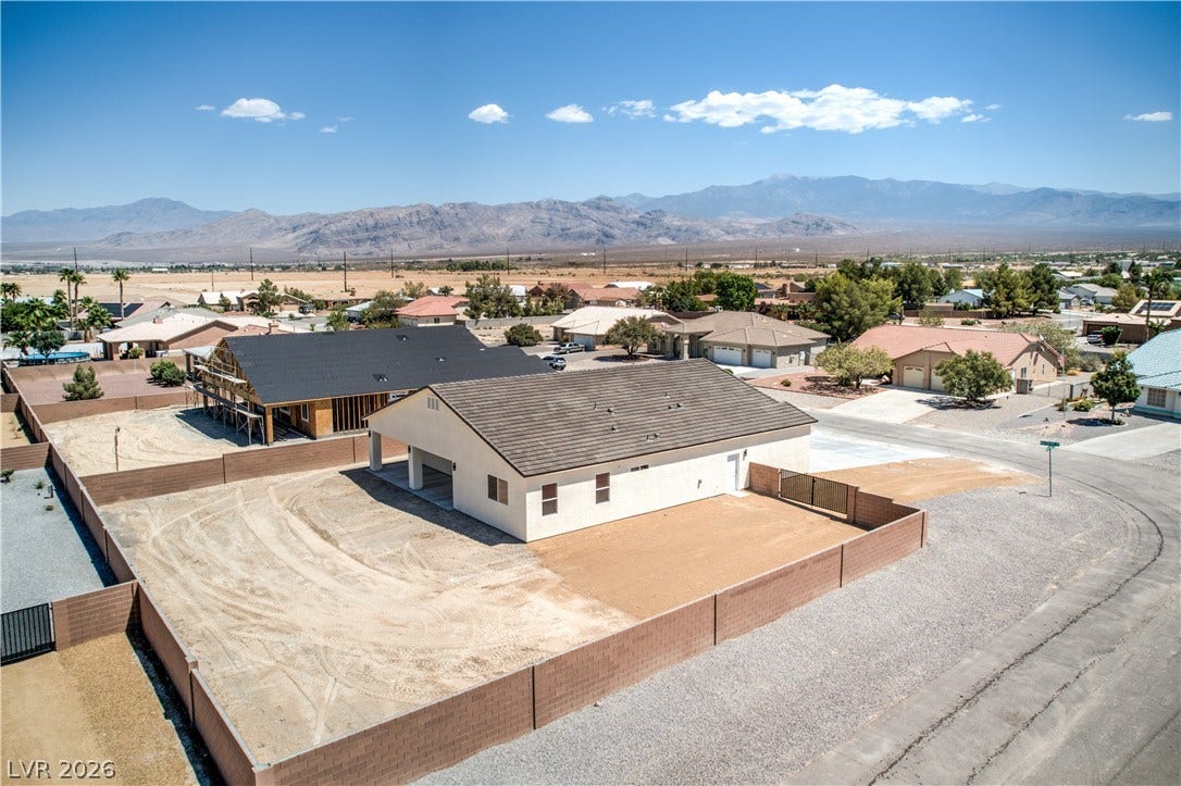 Aerial perspective of suburban area with a mountainous background