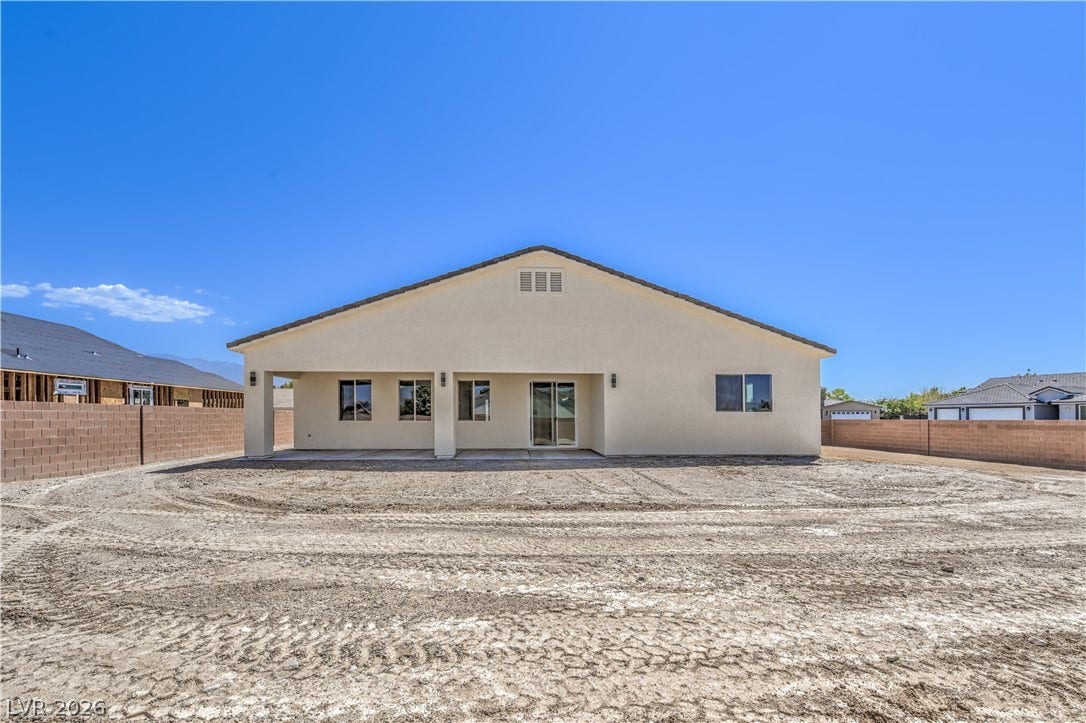 Back of property with a patio area, a fenced backyard, and stucco siding