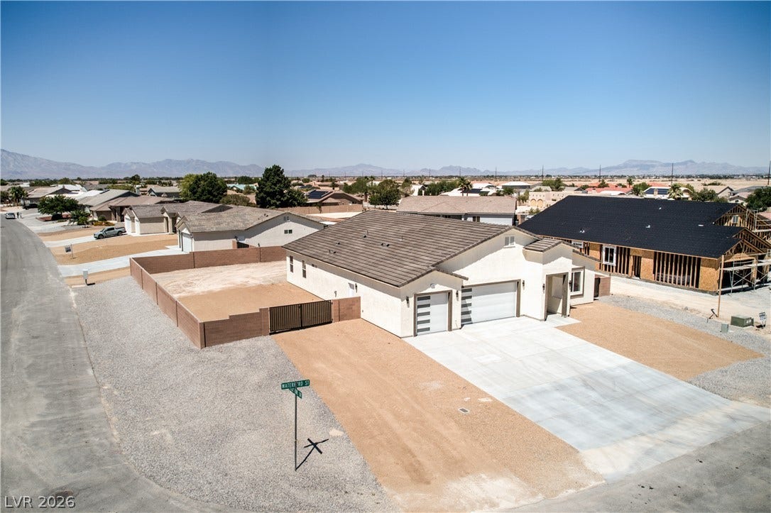 Aerial perspective of suburban area with a mountain backdrop