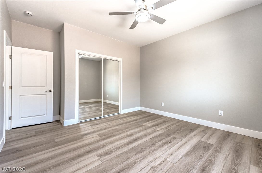 Unfurnished bedroom featuring light wood-style floors, ceiling fan, and a closet
