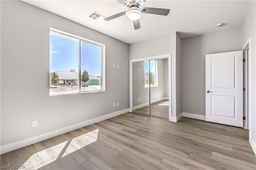 Unfurnished bedroom with light wood-style flooring, a ceiling fan, and a closet