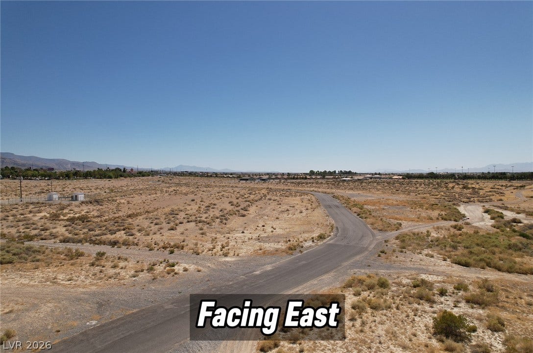 1060 S Firebird Circle, Pahrump, NV 89048 Distant mountains frame a wide desert landscape under clear blue skies.
