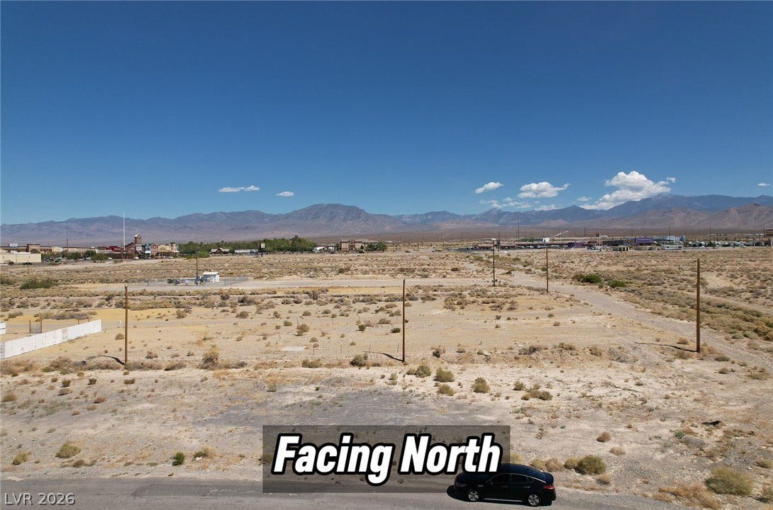 1060 S Firebird Circle, Pahrump, NV 89048 Distant mountain peaks rise above this desert acreage under clear blue skies.