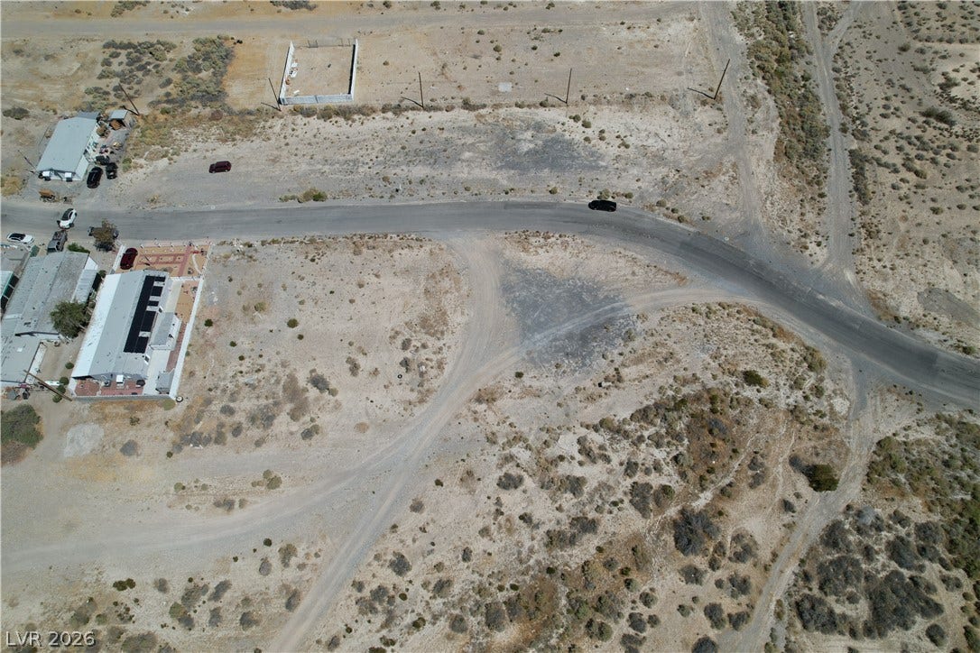 1060 S Firebird Circle, Pahrump, NV 89048 An aerial perspective showcases a spacious desert lot bordered by paved and unpaved roads.