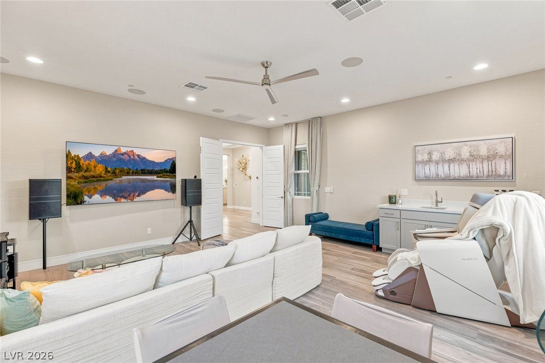 Gleaming wood floors and recessed lighting enhance this versatile multi-use living space.
