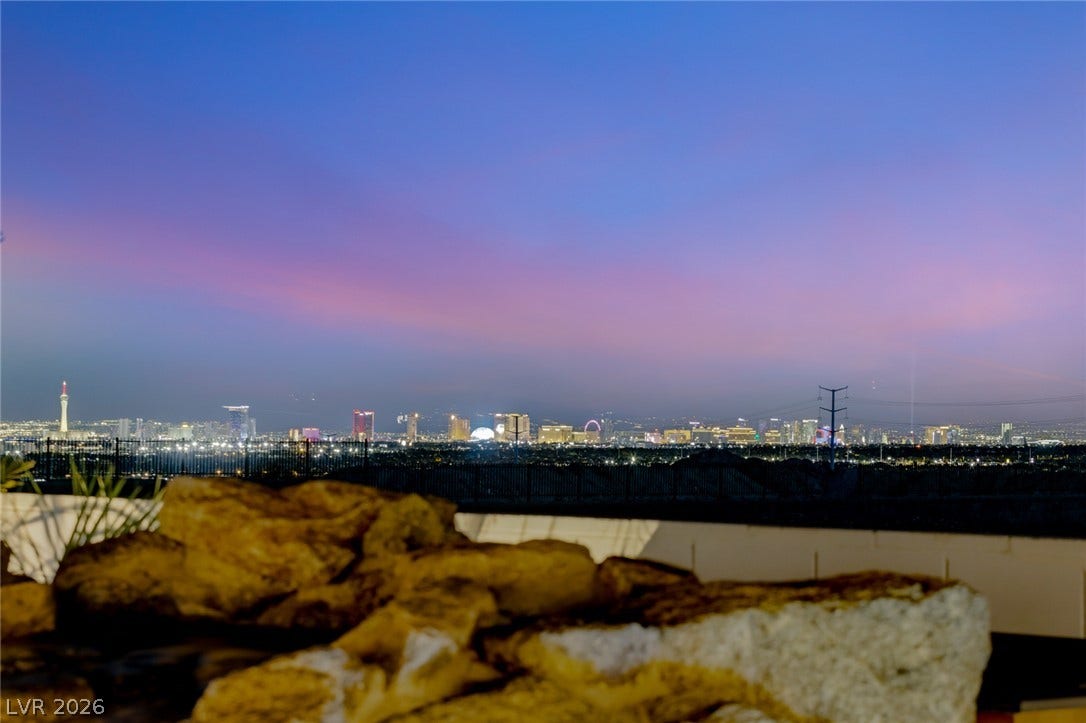 Gaze across the sparkling city skyline as evening colors paint the horizon.