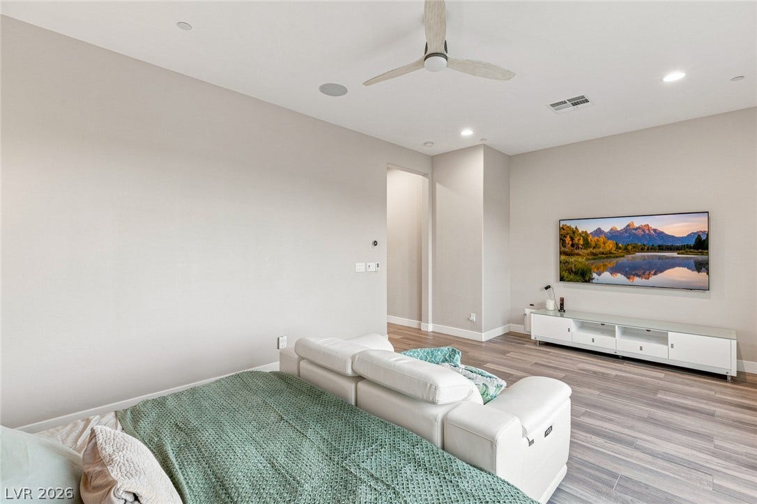 Smooth wood flooring and clean architectural lines define this comfortable living space.