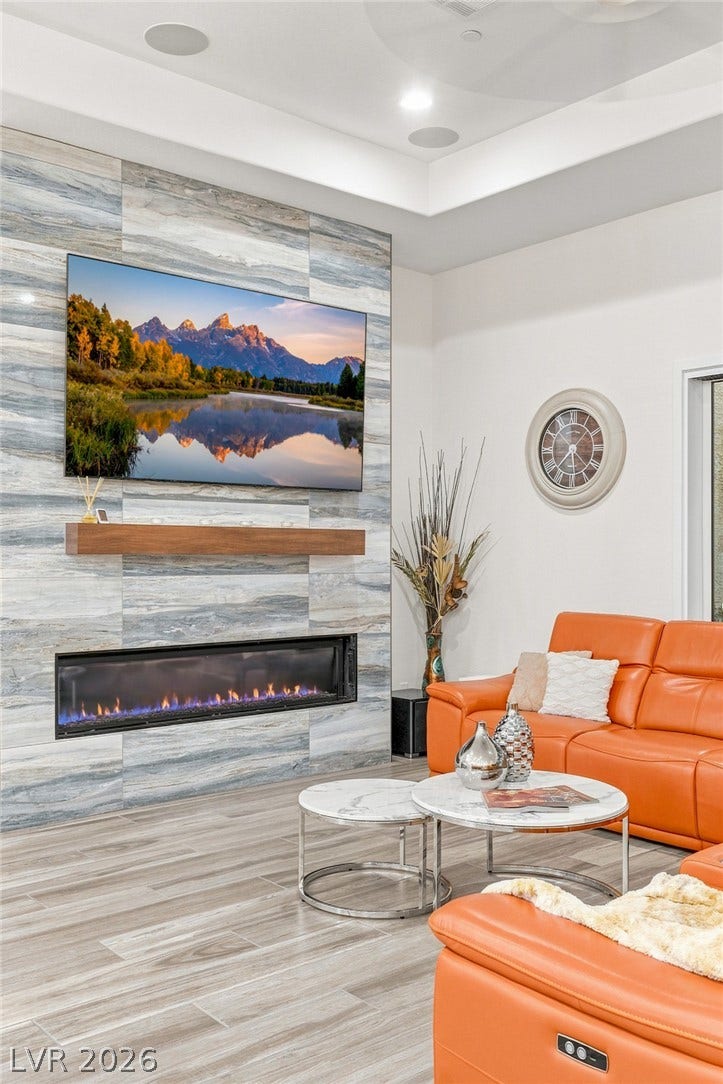 A modern tiled fireplace wall serves as the focal point in this inviting living area.