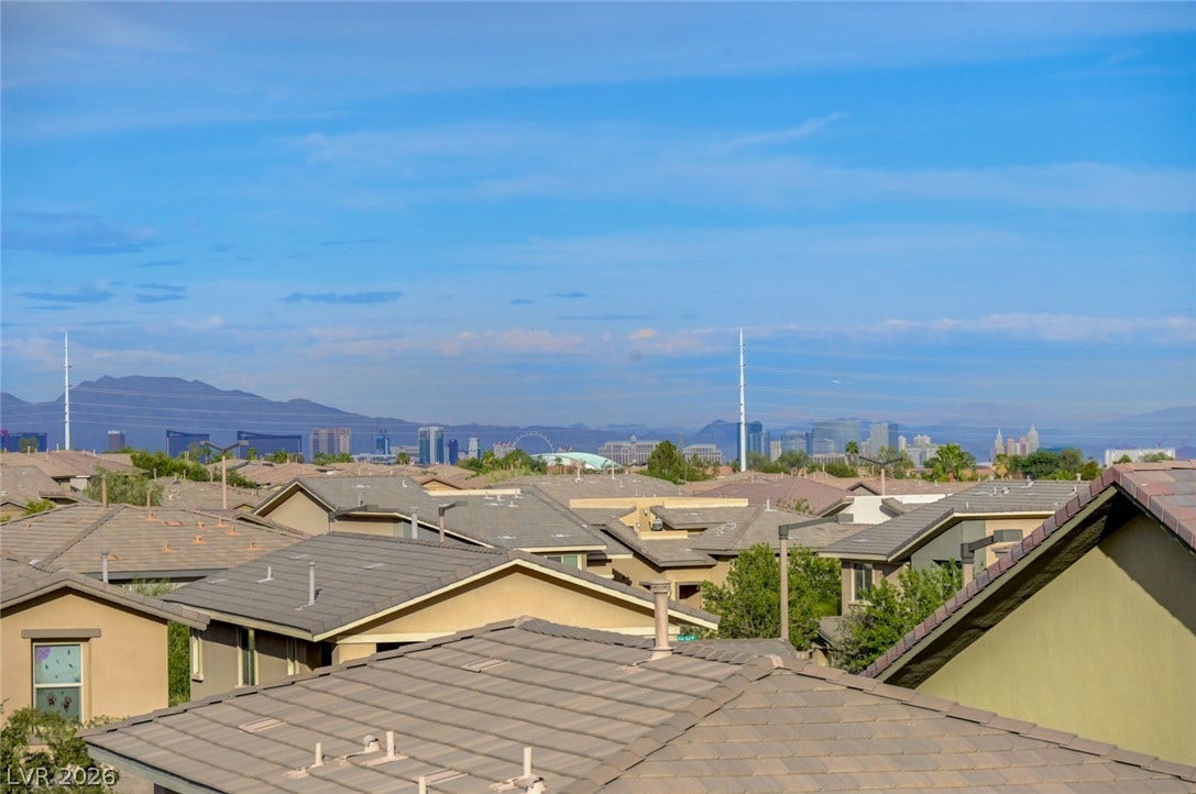 5608 Beckett Hill Court, Las Vegas, NV 89135 Distant city skyline panoramas unfold above the surrounding neighborhood rooftops.