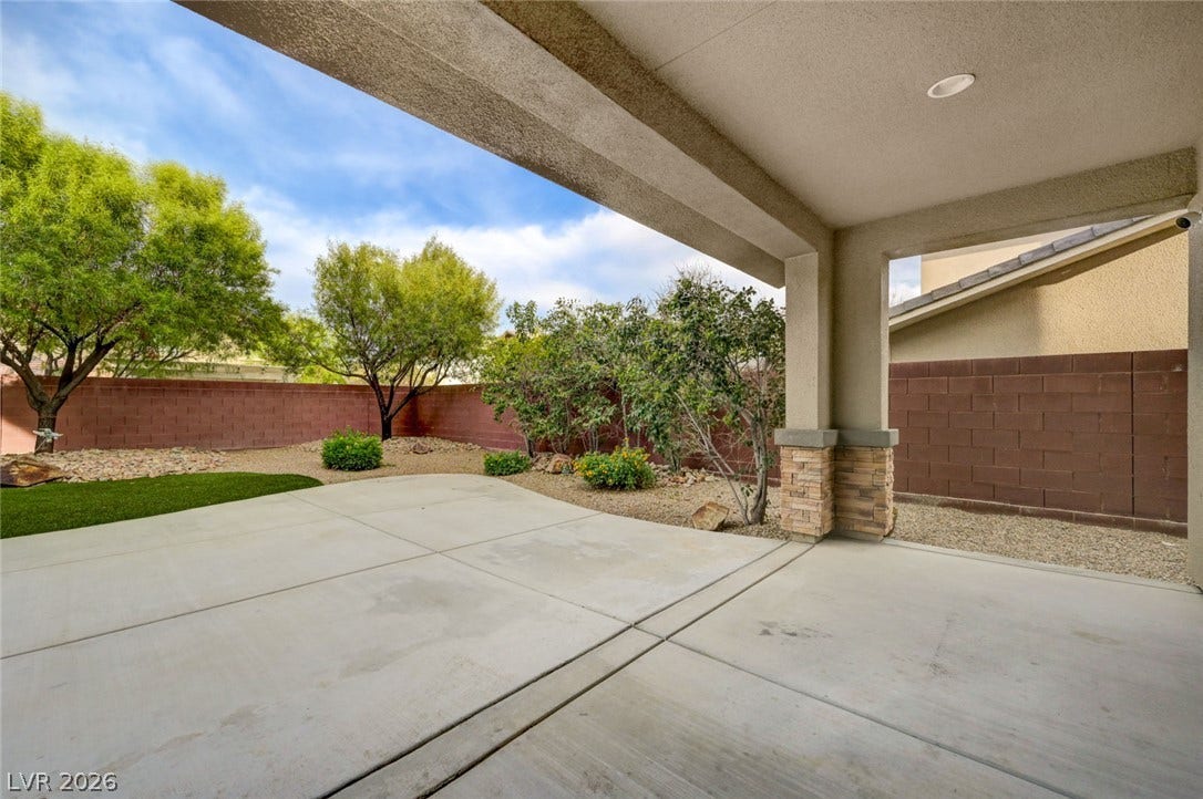 5608 Beckett Hill Court, Las Vegas, NV 89135 A spacious covered patio overlooks a private, low-maintenance backyard enclosed by brick walls.