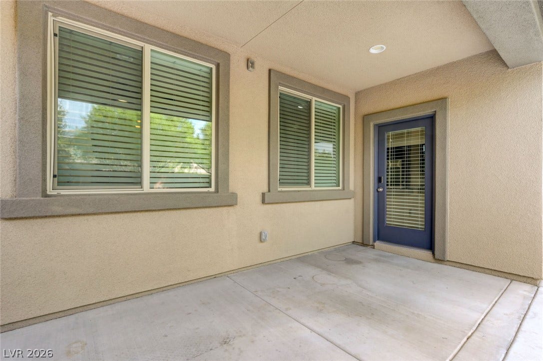 5608 Beckett Hill Court, Las Vegas, NV 89135 Concrete surfacing and clean stucco walls define this sheltered outdoor patio space.