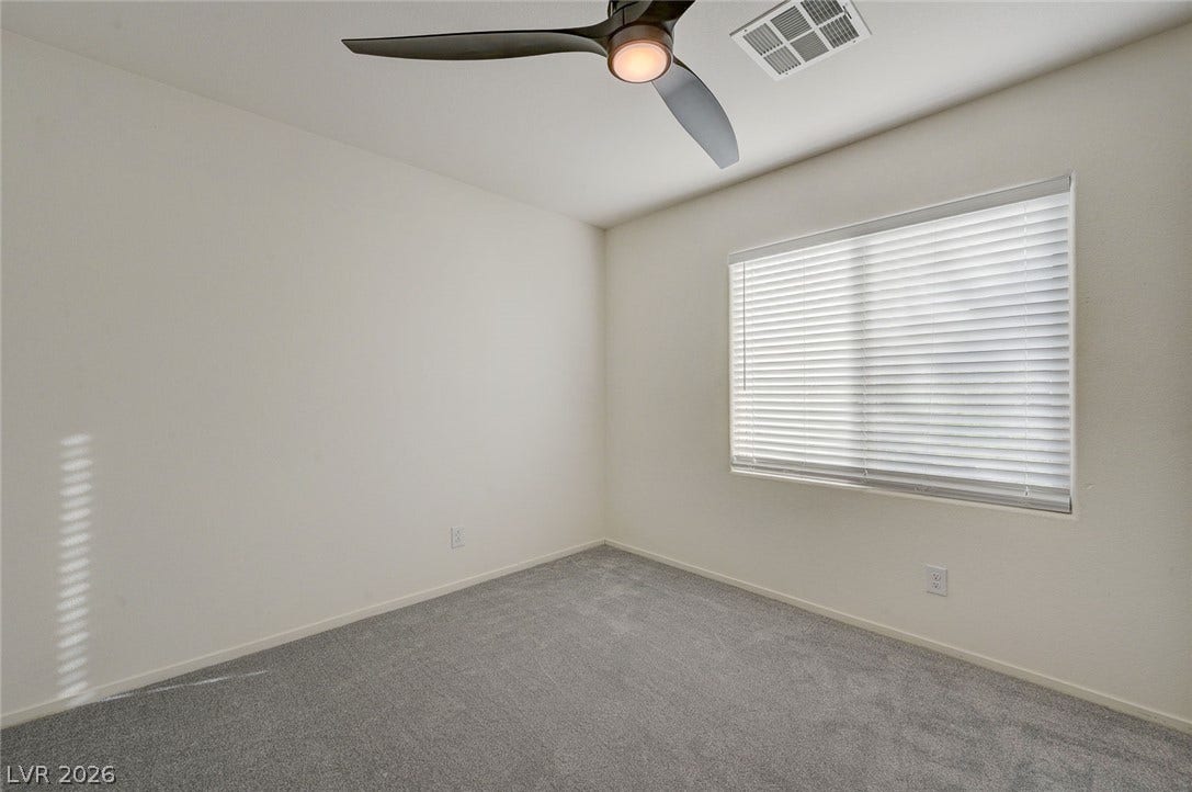 5608 Beckett Hill Court, Las Vegas, NV 89135 Soft carpeting pairs with neat trim and a large window in this quiet space.
