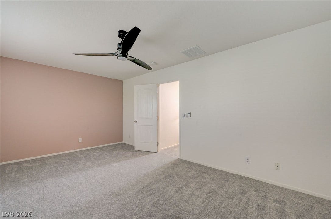 5608 Beckett Hill Court, Las Vegas, NV 89135 Soft carpet and clean plaster walls define this versatile private space.