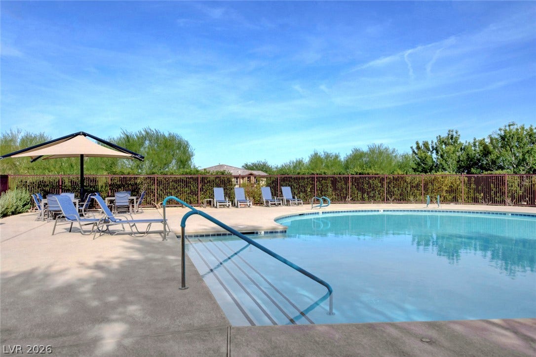 5608 Beckett Hill Court, Las Vegas, NV 89135 A sparkling swimming pool sits surrounded by a concrete patio and secure perimeter fencing.