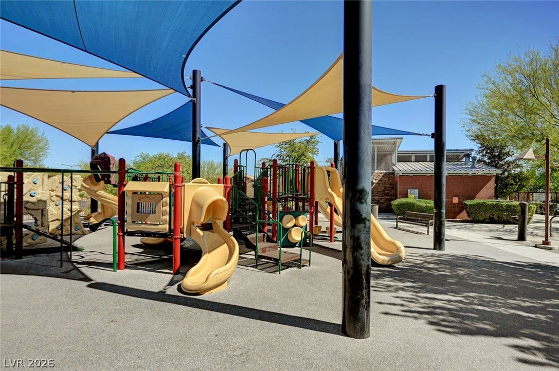 5608 Beckett Hill Court, Las Vegas, NV 89135 A shaded playground structure sits on a paved surface under protective sun sails.