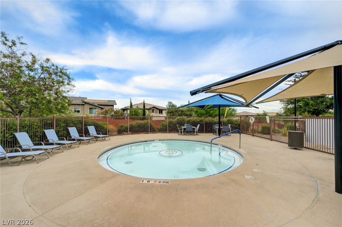 5608 Beckett Hill Court, Las Vegas, NV 89135 Shaded lounge areas surround a pristine circular pool enclosed by secure fencing.
