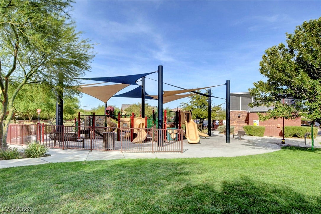 5608 Beckett Hill Court, Las Vegas, NV 89135 Fenced community playground features modern shade sails alongside a lush green lawn.