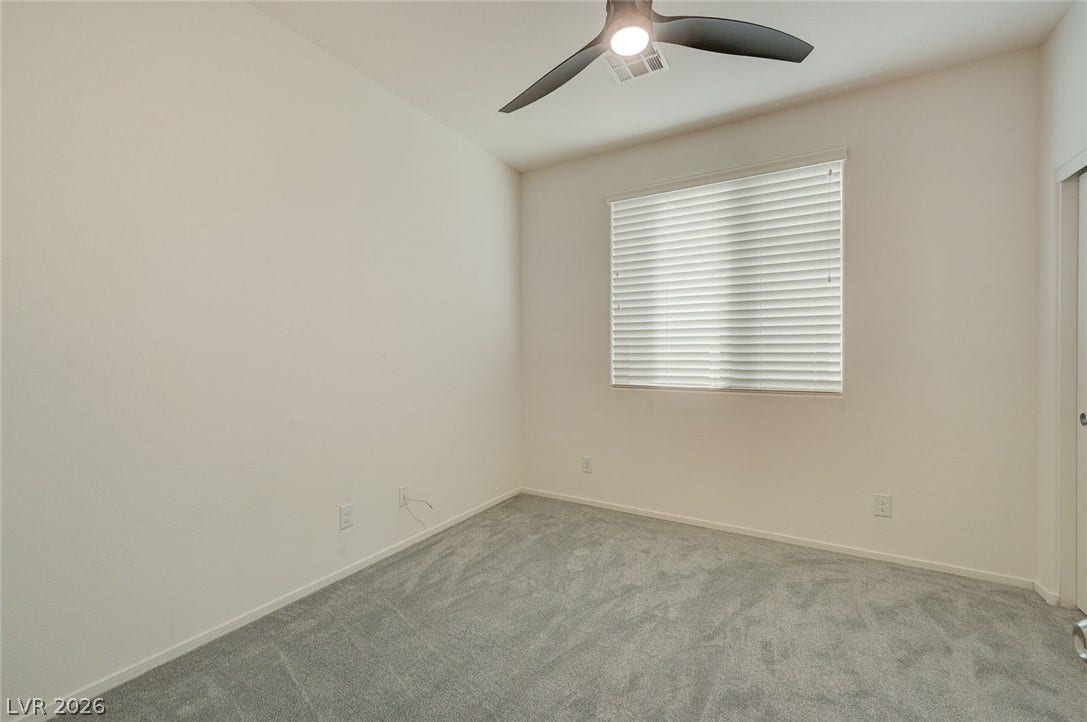5608 Beckett Hill Court, Las Vegas, NV 89135 Plush carpeting and a large window create a comfortable and inviting atmosphere in this room.