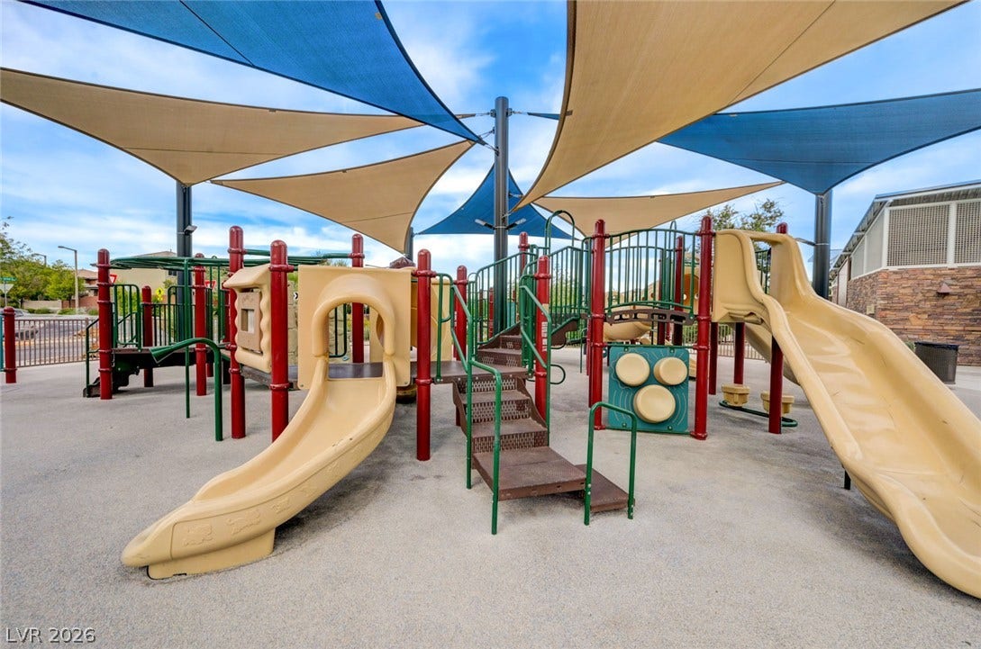 5608 Beckett Hill Court, Las Vegas, NV 89135 An expansive outdoor play area features multiple slides sheltered under large sun shade sails.