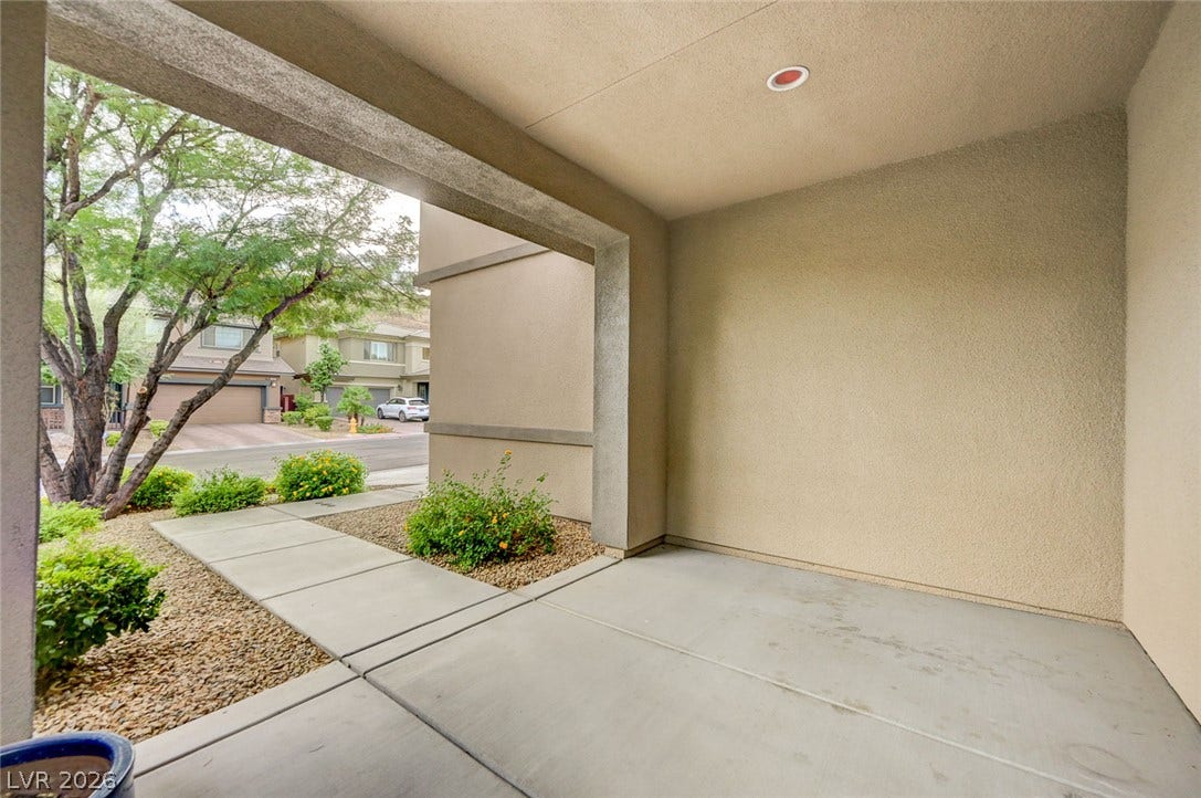 5608 Beckett Hill Court, Las Vegas, NV 89135 Concrete walkways lead to a covered entryway featuring clean lines and a recessed light.