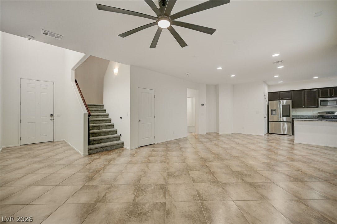 5608 Beckett Hill Court, Las Vegas, NV 89135 An open layout flows seamlessly across large-format tile flooring beneath recessed lighting.