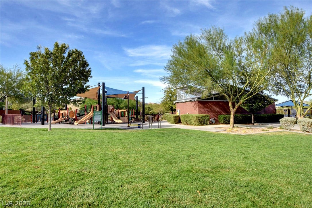 5608 Beckett Hill Court, Las Vegas, NV 89135 Green lawns surround the neighborhood community park and playground facilities under clear blue skies.