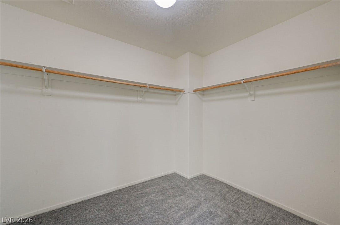 5608 Beckett Hill Court, Las Vegas, NV 89135 Ample hanging rods and soft carpeting define this functional storage space.