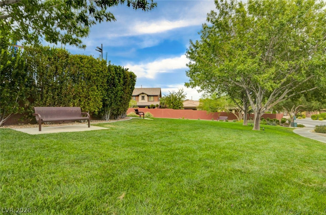 5608 Beckett Hill Court, Las Vegas, NV 89135 Mature trees and neat concrete pathways frame a manicured green lawn.