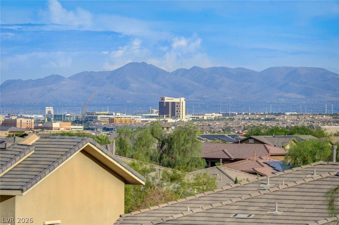 5608 Beckett Hill Court, Las Vegas, NV 89135 Majestic mountain ridges rise beyond the surrounding rooftops under a bright desert sky.