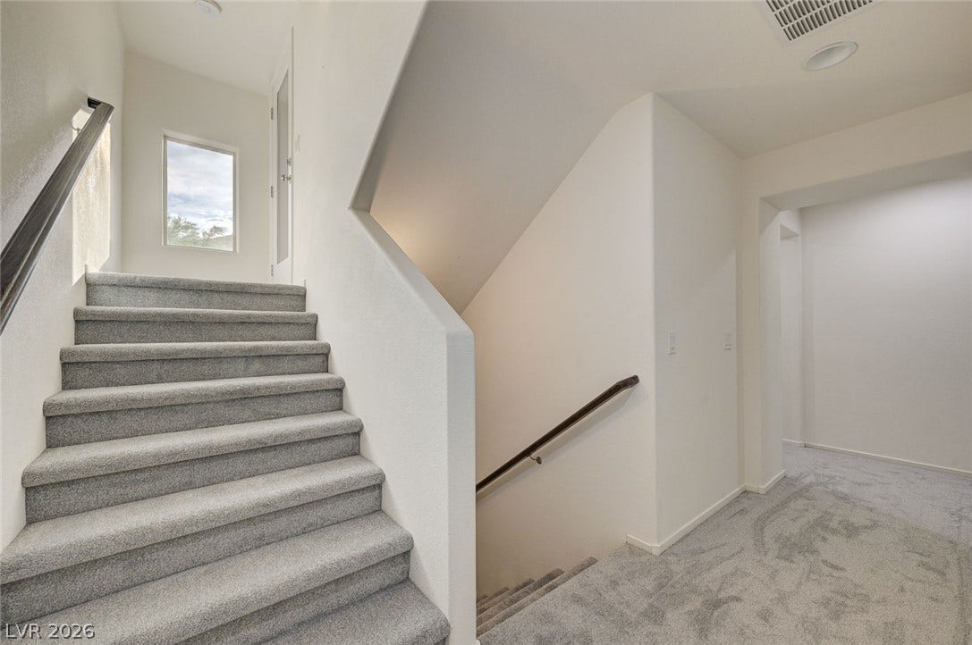 5608 Beckett Hill Court, Las Vegas, NV 89135 Carpeted stairs with contemporary handrails connect the different levels of this home.