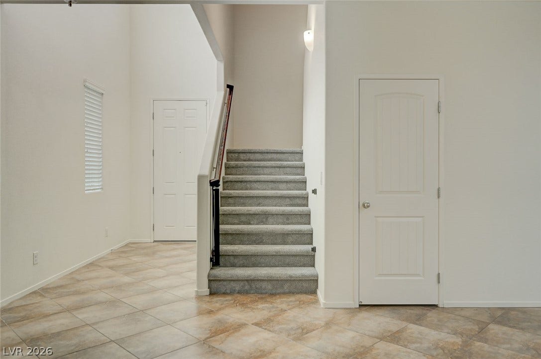 5608 Beckett Hill Court, Las Vegas, NV 89135 A soaring ceiling rises above the tiled entry hall and carpeted staircase.