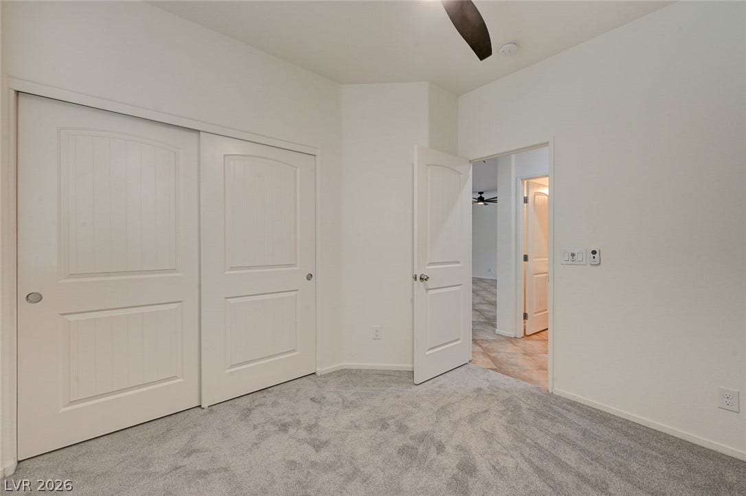 5608 Beckett Hill Court, Las Vegas, NV 89135 Soft carpeting underfoot anchors this minimalist space featuring ample built-in closet storage.
