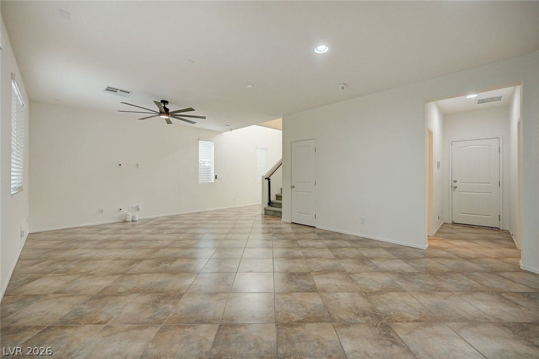 5608 Beckett Hill Court, Las Vegas, NV 89135 Continuous tile flooring spans this airy open-concept space leading toward the entryway and stairs.