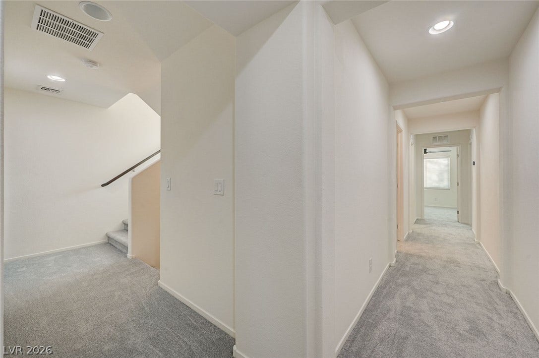 5608 Beckett Hill Court, Las Vegas, NV 89135 Recessed lighting and soft carpeting guide the way through this bright upstairs landing.