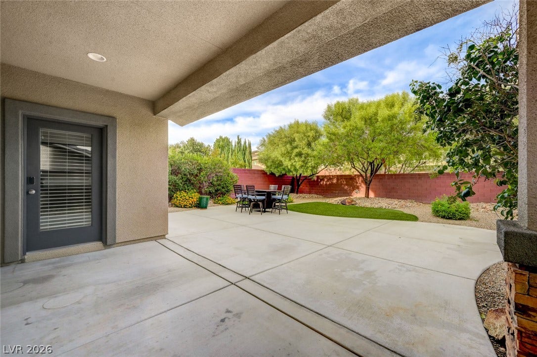 5608 Beckett Hill Court, Las Vegas, NV 89135 A spacious covered patio overlooks the manicured concrete terrace and private fenced yard.