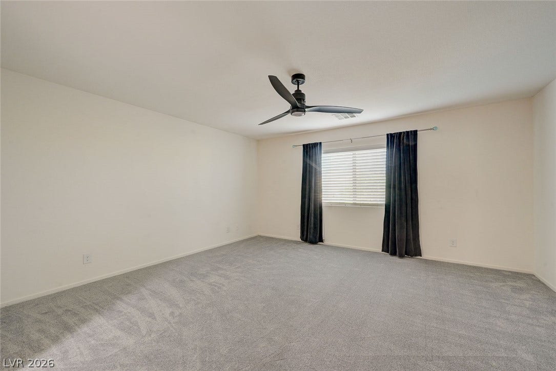 5608 Beckett Hill Court, Las Vegas, NV 89135 Plush carpeting anchors this versatile room centered around a classic window.