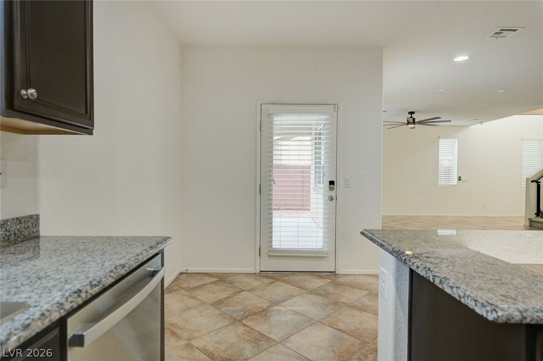 5608 Beckett Hill Court, Las Vegas, NV 89135 Polished stone countertops complement tiled flooring that flows seamlessly into the main living areas.