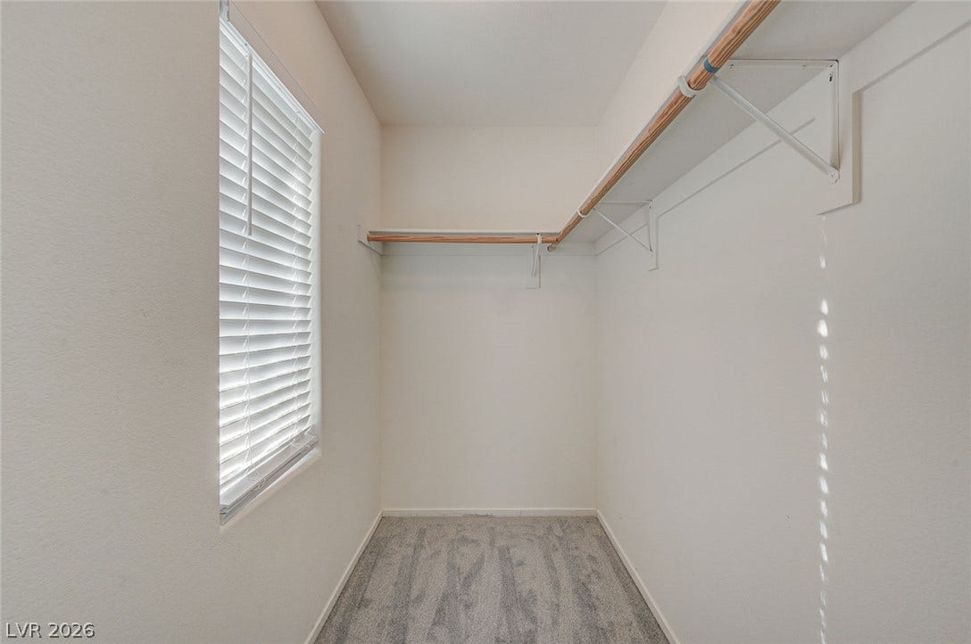 5608 Beckett Hill Court, Las Vegas, NV 89135 Ample closet space features plush carpeting and integrated wooden hanging rods with shelving.